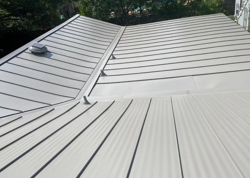 Solar attic fan installed on a metal roof for Roof Ventilation in Payette